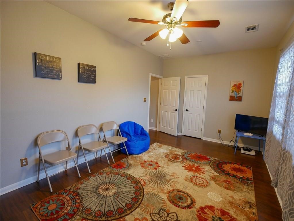 702 South Frontier Lane Cedar Park, TX 78613 - Photo 10 of 30 a bedroom with a bed and a chandelier