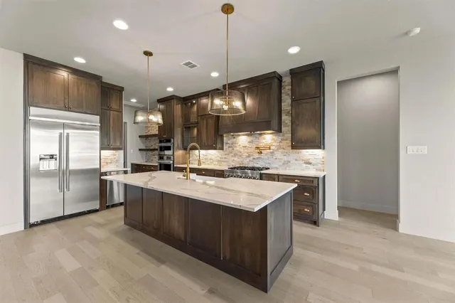 a kitchen with a sink stove and refrigerator