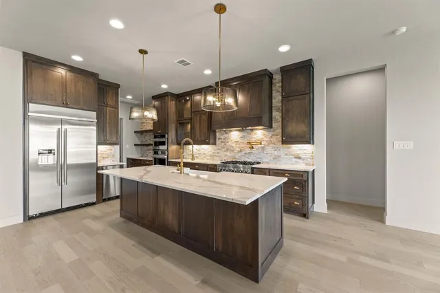 a kitchen with a sink stove and refrigerator
