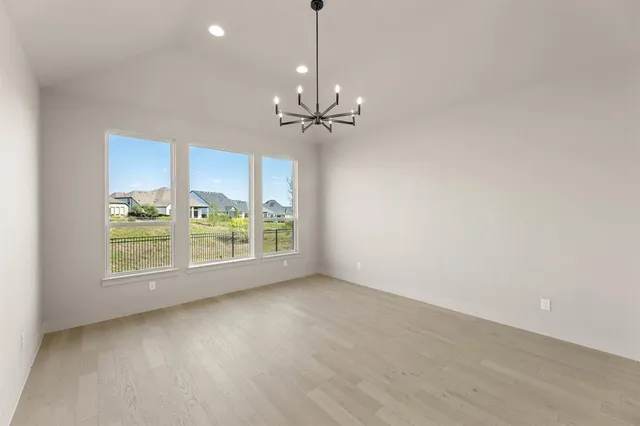 a view of a room with a ceiling fan and a window