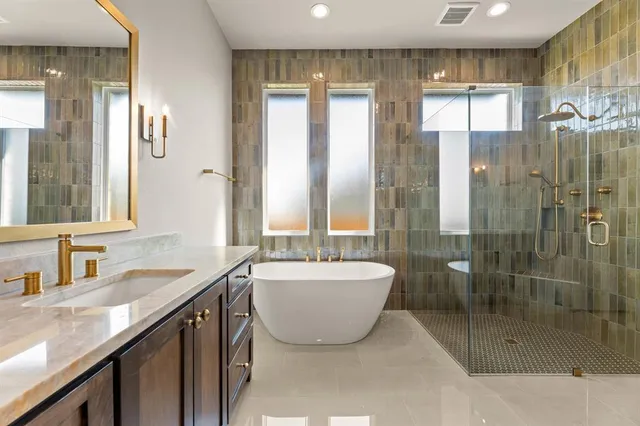 a bathroom with a granite countertop sink a toilet a mirror and shower