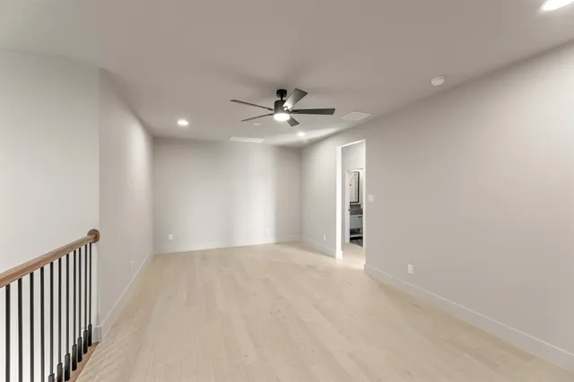 a view of a livingroom with a ceiling fan and window