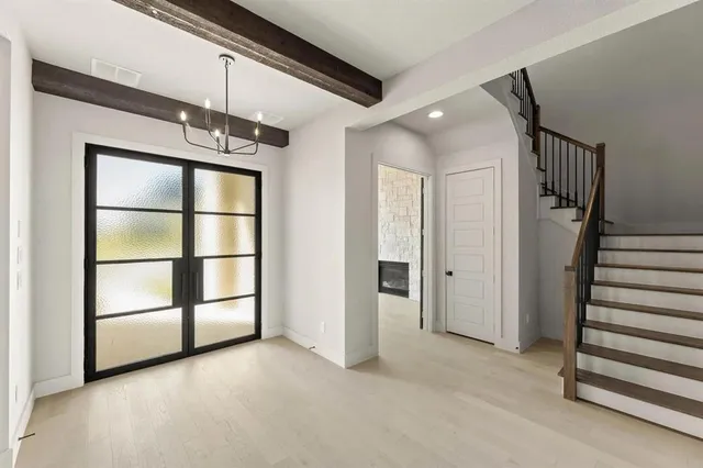 a view of a livingroom with wooden floor and staircase