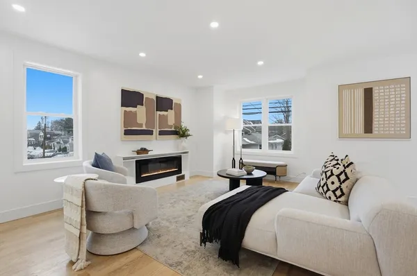 a bedroom with furniture a fireplace and a window