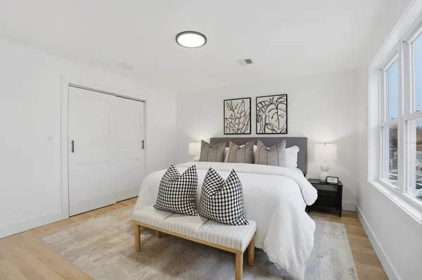 a bedroom with a bed and a window