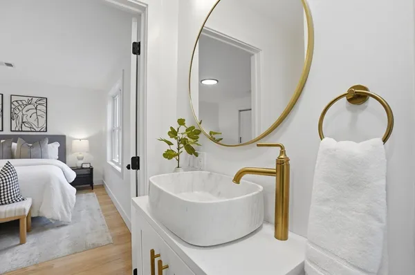 a bathroom with a tub sink and mirror