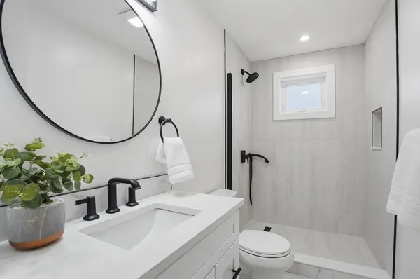 a bathroom with a sink toilet and shower