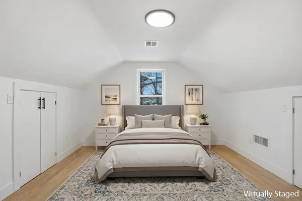 a bedroom with a bed and a painting on the wall