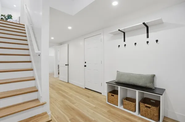 a view of an empty room with wooden floor and entryway