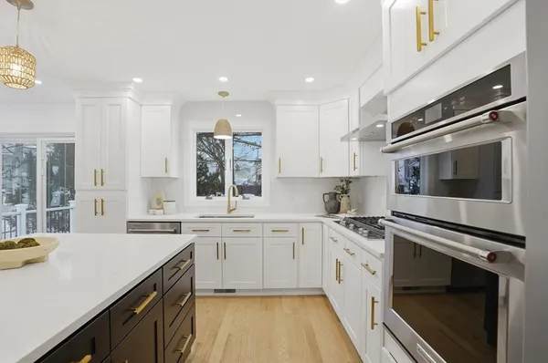 a kitchen with a sink stove and cabinets