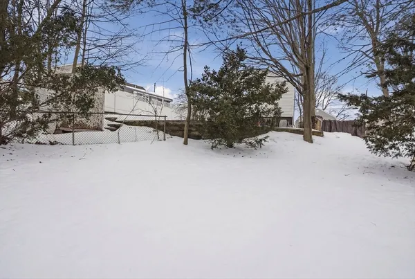 a view of a house with a snow in the yard