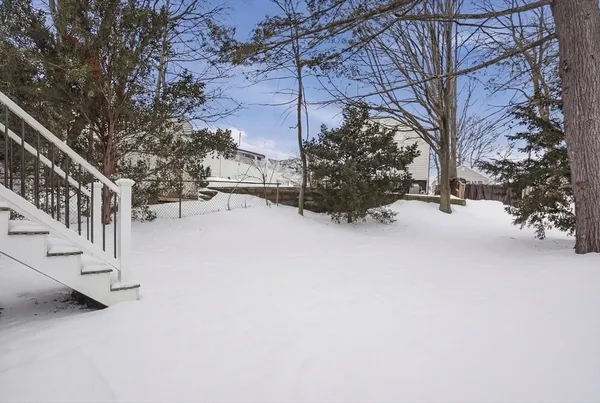 a view of a house with a snow in a yard