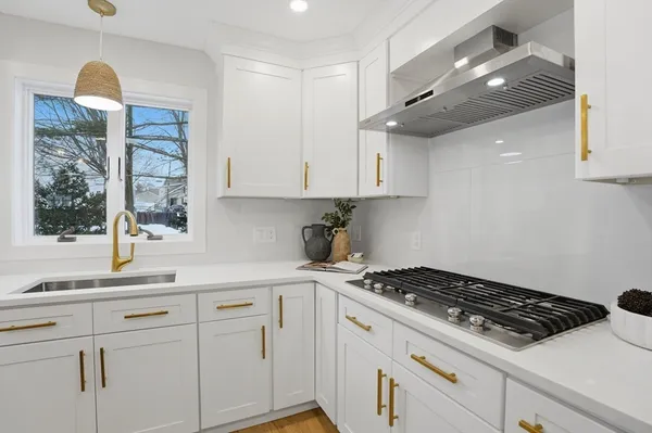 a kitchen with granite countertop a sink stainless steel appliances and cabinets
