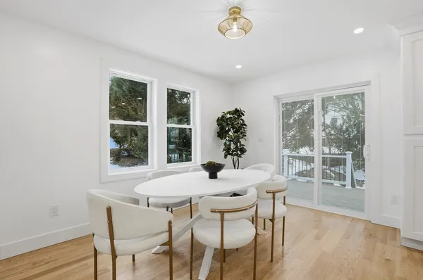 a dining room with furniture window and wooden floor