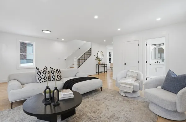 a living room with furniture and a chandelier