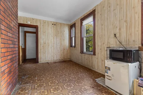 a view of a livingroom with an empty space and a window