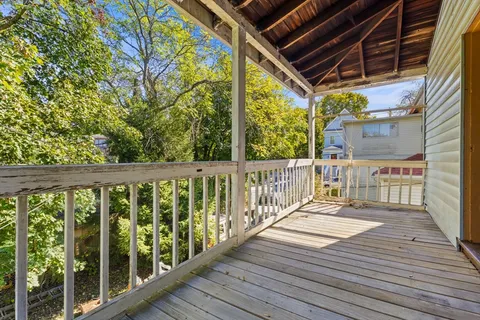 a view of a balcony with wooden floor
