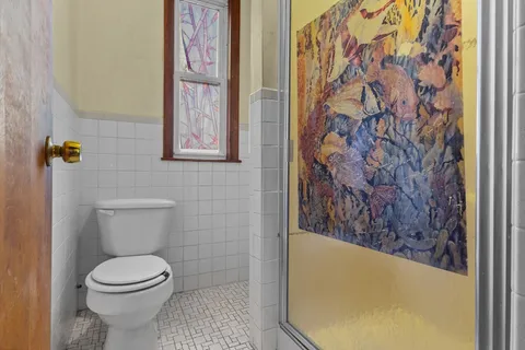 a bathroom with a toilet and a shower curtain