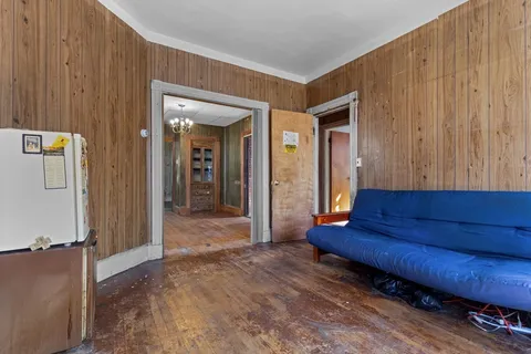a view of a hallway with wooden floor and entryway