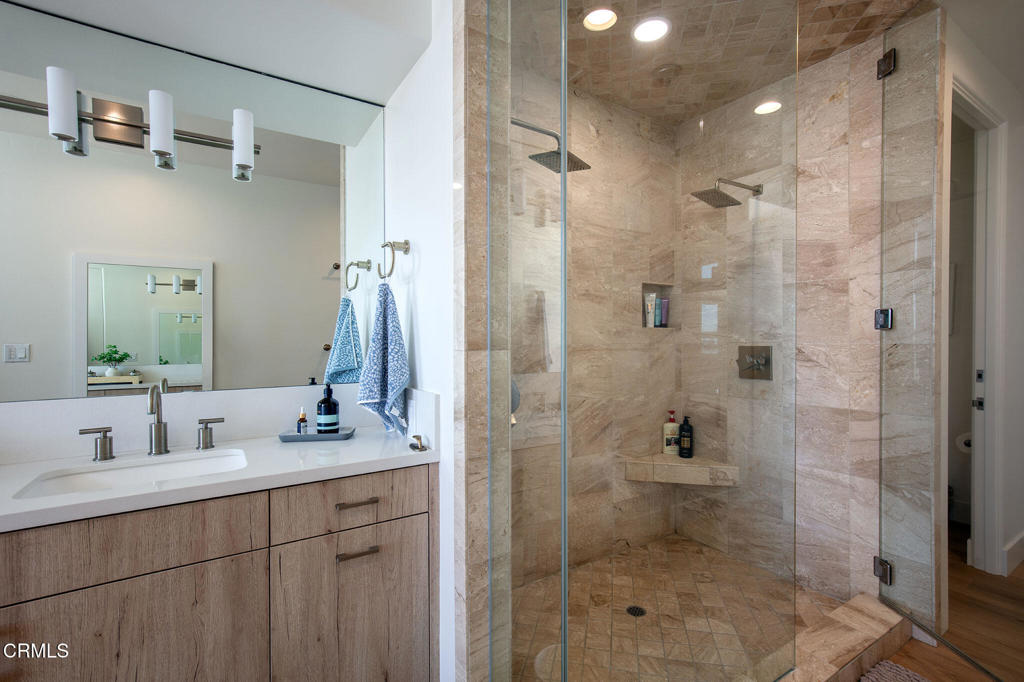 815 Mandalay Beach Road Oxnard, CA 93035 - Photo 11 of 29 a bathroom with a shower sink and mirror