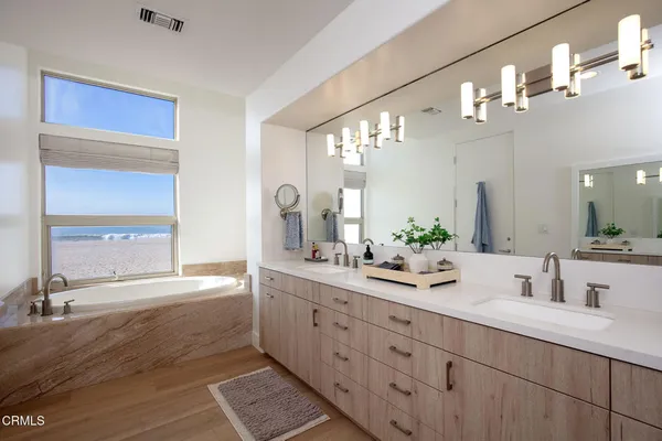 a bathroom with a sink double vanity granite and a mirror