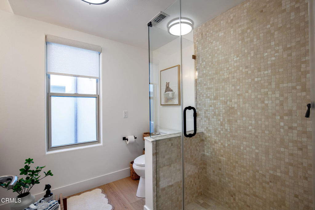815 Mandalay Beach Road Oxnard, CA 93035 - Photo 21 of 29 a bathroom with a toilet and a shower