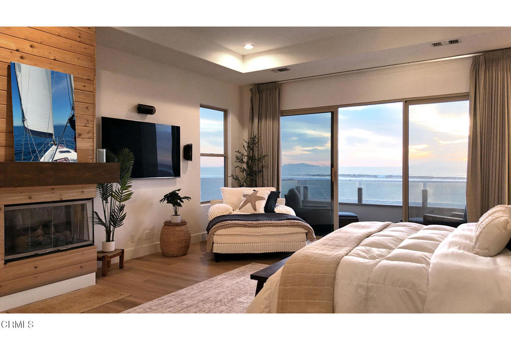 815 Mandalay Beach Road Oxnard, CA 93035 - Photo 22 of 29 a bedroom with a bed a flat screen tv and a fireplace