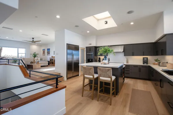 a kitchen with stainless steel appliances kitchen island granite countertop a sink and cabinets