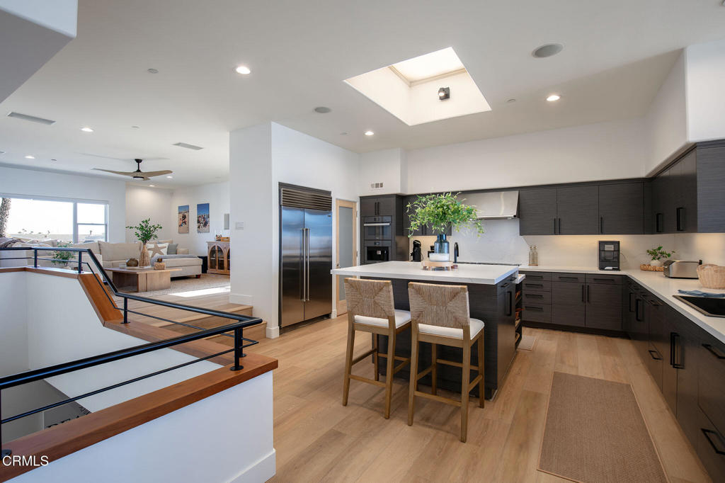 815 Mandalay Beach Road Oxnard, CA 93035 - Photo 3 of 29 a kitchen with stainless steel appliances kitchen island granite countertop a sink and cabinets