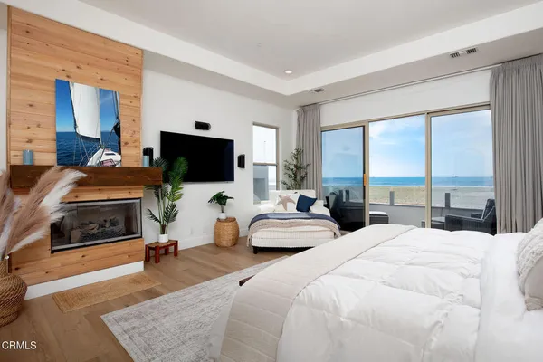 a bedroom with a bed and large windows