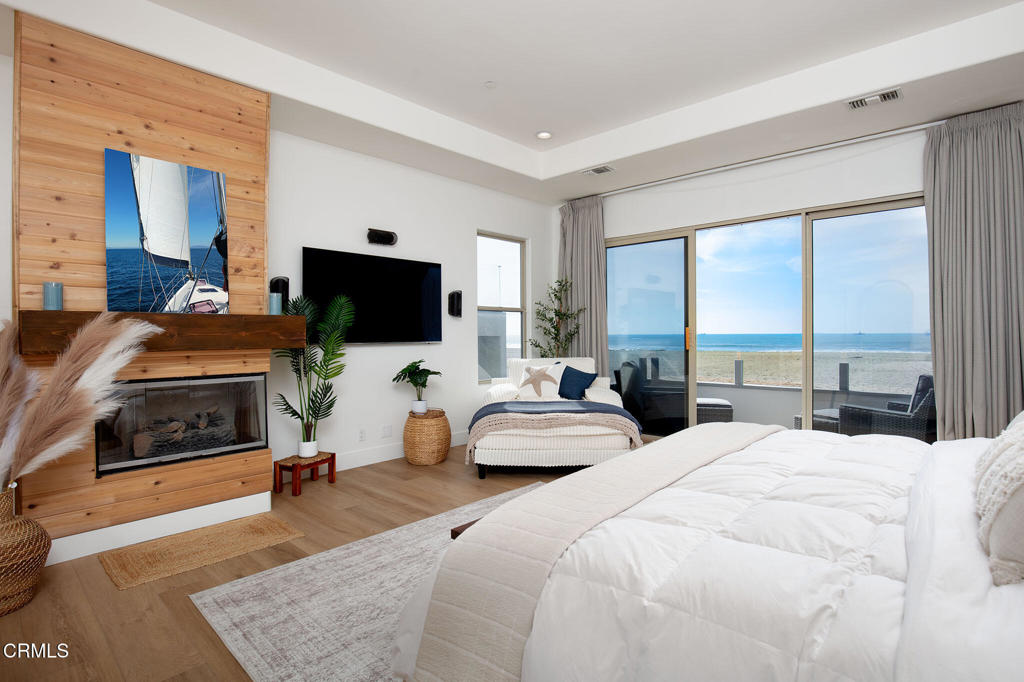 815 Mandalay Beach Road Oxnard, CA 93035 - Photo 9 of 29 a bedroom with a bed and large windows