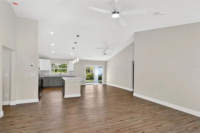 a kitchen with a wooden floor and window