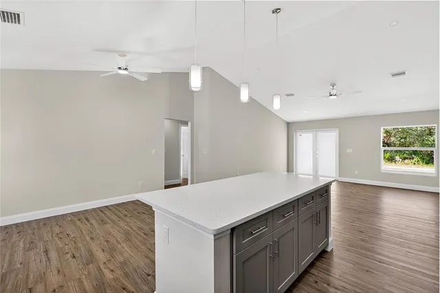 a bedroom with a large bed a flat tv screen and a dresser
