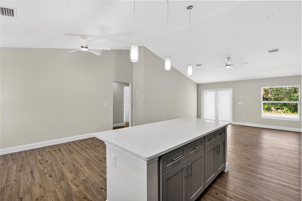 486 Celeste Street Port Charlotte, FL 33954 - Photo 15 of 35 a kitchen with a wooden floor and window