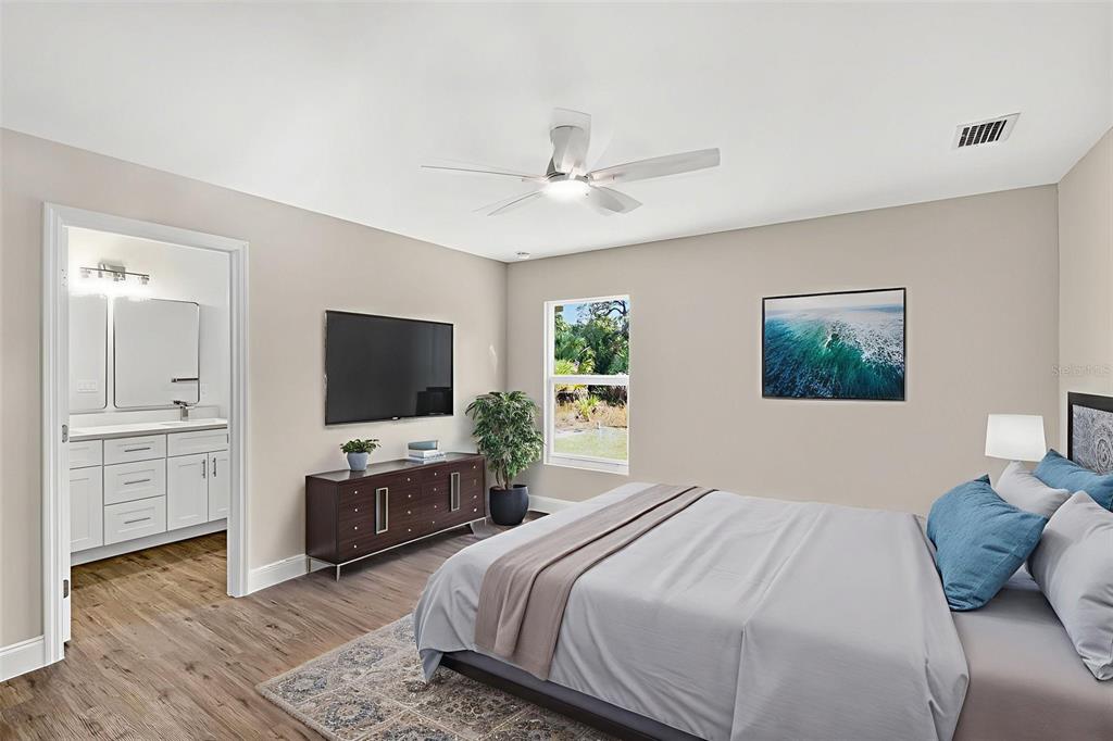 486 Celeste Street Port Charlotte, FL 33954 - Photo 16 of 35 a bedroom with a large bed a flat tv screen and a dresser