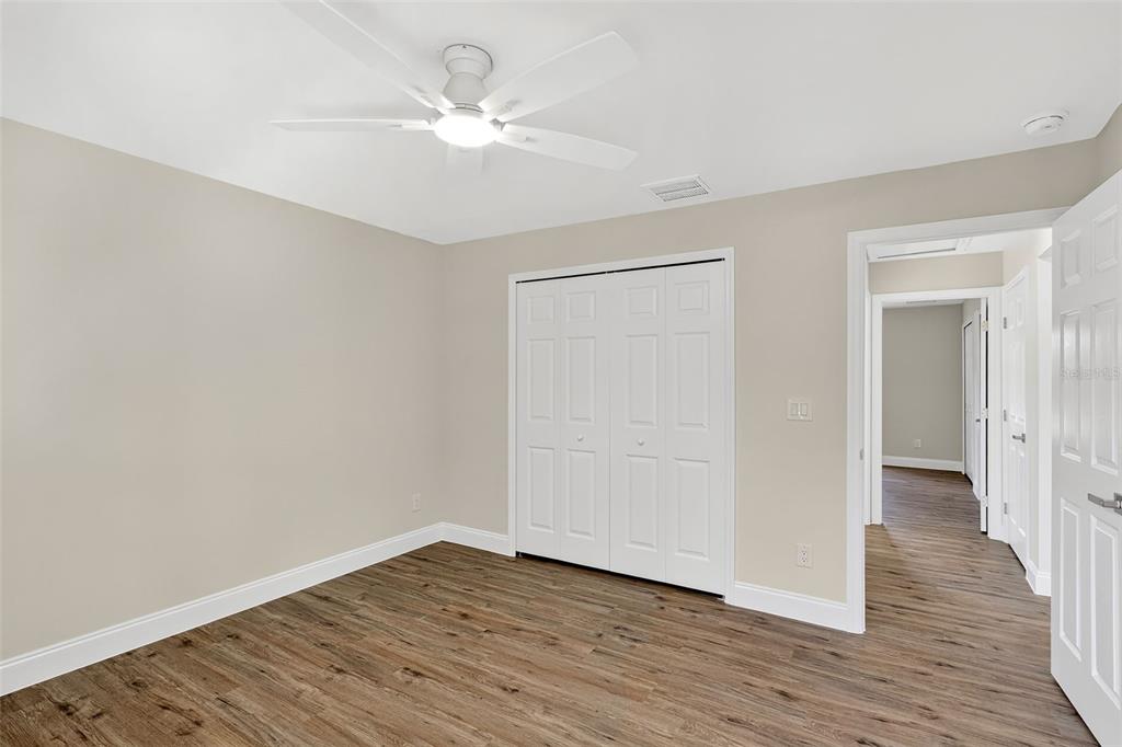 486 Celeste Street Port Charlotte, FL 33954 - Photo 24 of 35 a view of an empty room with wooden floor