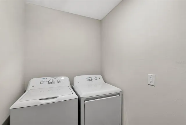 a living room with furniture and a ceiling fan