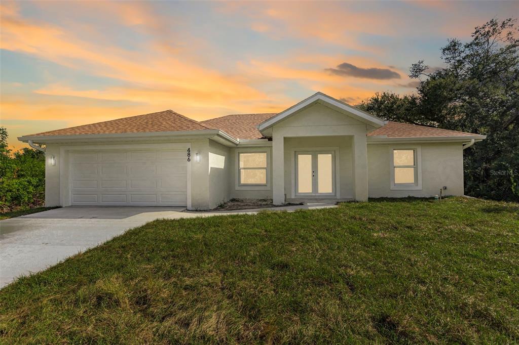486 Celeste Street Port Charlotte, FL 33954 - Photo 3 of 35 front view of a house with a yard