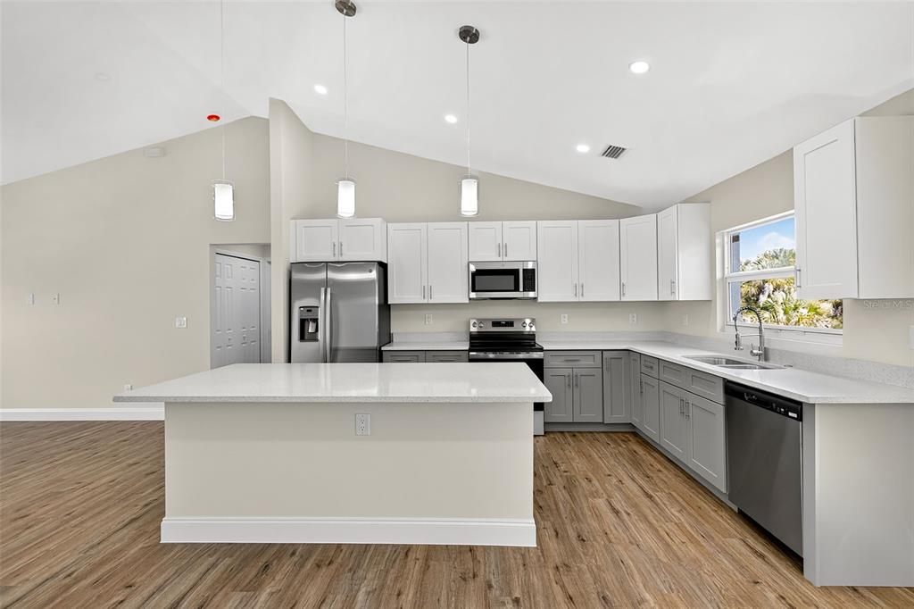 486 Celeste Street Port Charlotte, FL 33954 - Photo 7 of 35 a large kitchen with stainless steel appliances lots of counter top space and cabinets