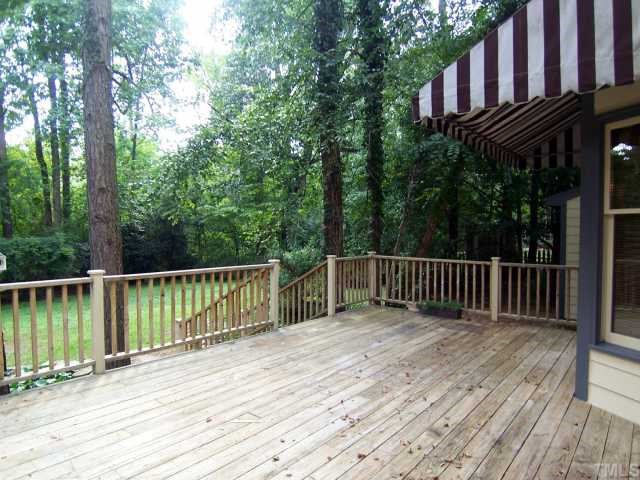 2216 Effingham Circle Raleigh, NC 27615 - Photo 11 of 12 Outside, the lg Deck leads down to the fenced & wooded backyard w/fish pond.