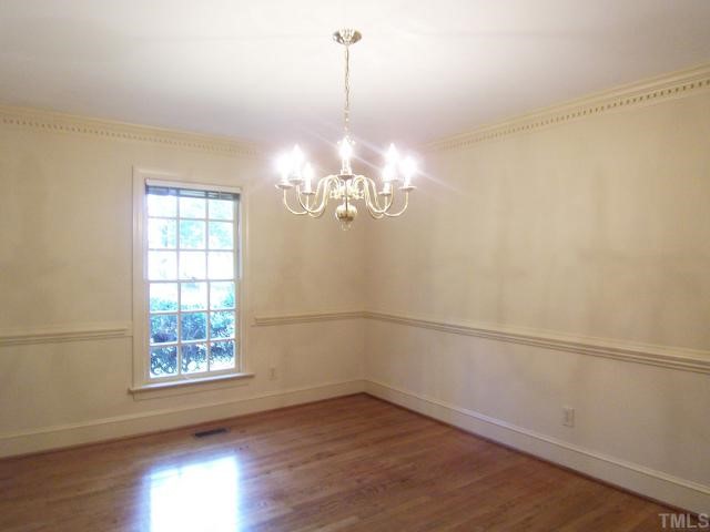 2216 Effingham Circle Raleigh, NC 27615 - Photo 3 of 12 The formal Dining Rm offers hrdwd flr, chair rail, dentil crown molding & swinging door to the Kitchen.