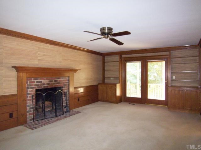 2216 Effingham Circle Raleigh, NC 27615 - Photo 6 of 12 Adjacent is the big front-to-back FamRm w/brick wood-burning FP, built in cabinetry, wood wainscot, neutral carpet & French drs to a covered porch overlooking the bkyd.
