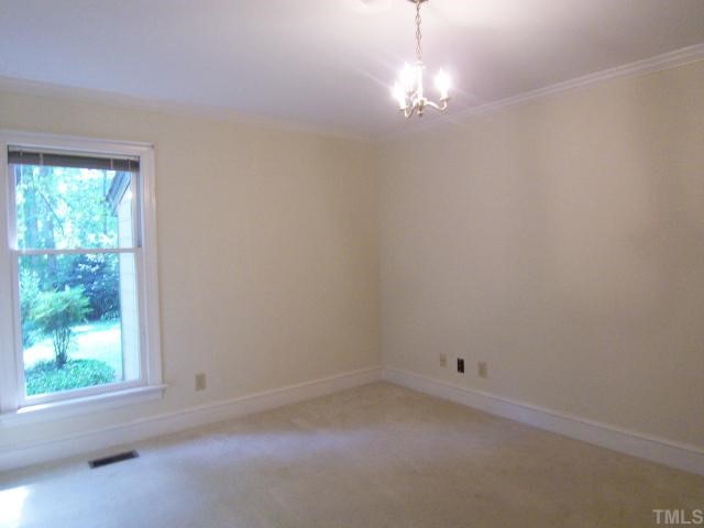 2216 Effingham Circle Raleigh, NC 27615 - Photo 7 of 12 Off the other side of the KIT is a spacious BR (could be an Office) w/neutral carpet, crown molding & 2 closets; a full Bath w/lg shower & dbl sinks; 3 linen closets and the convenient Laundry closet.