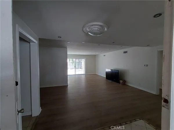 a view of room with window and wooden floor