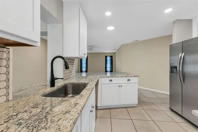 a kitchen with cabinets stainless steel appliances and a sink