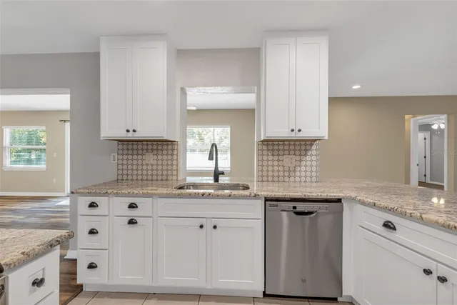 a kitchen with kitchen island a counter top space and cabinets