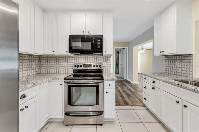 a view of an empty room with closet and a window