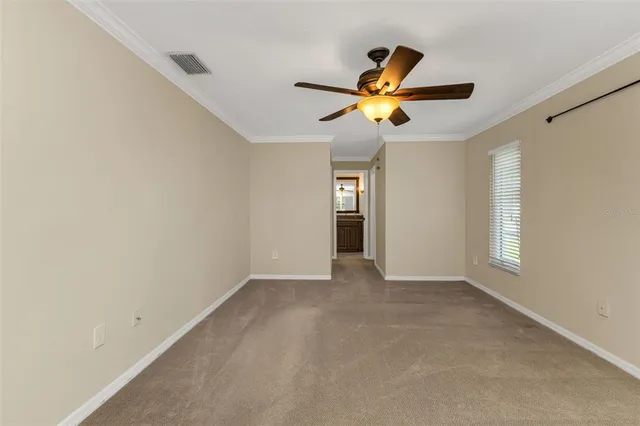 a view of walk in closet with empty racks