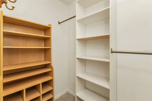 a bathroom with a granite countertop sink a mirror and shower
