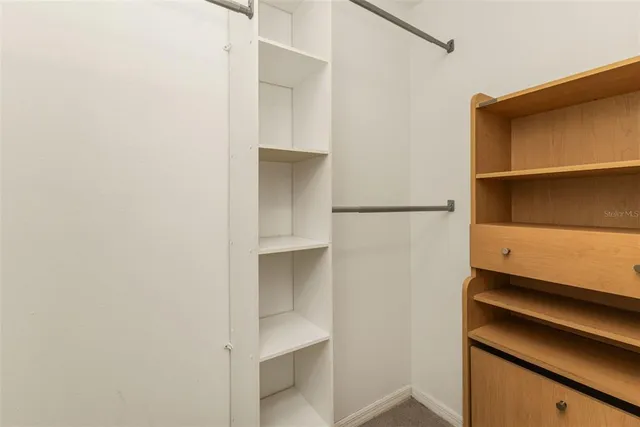 a bathroom with a granite countertop sink and a toilet